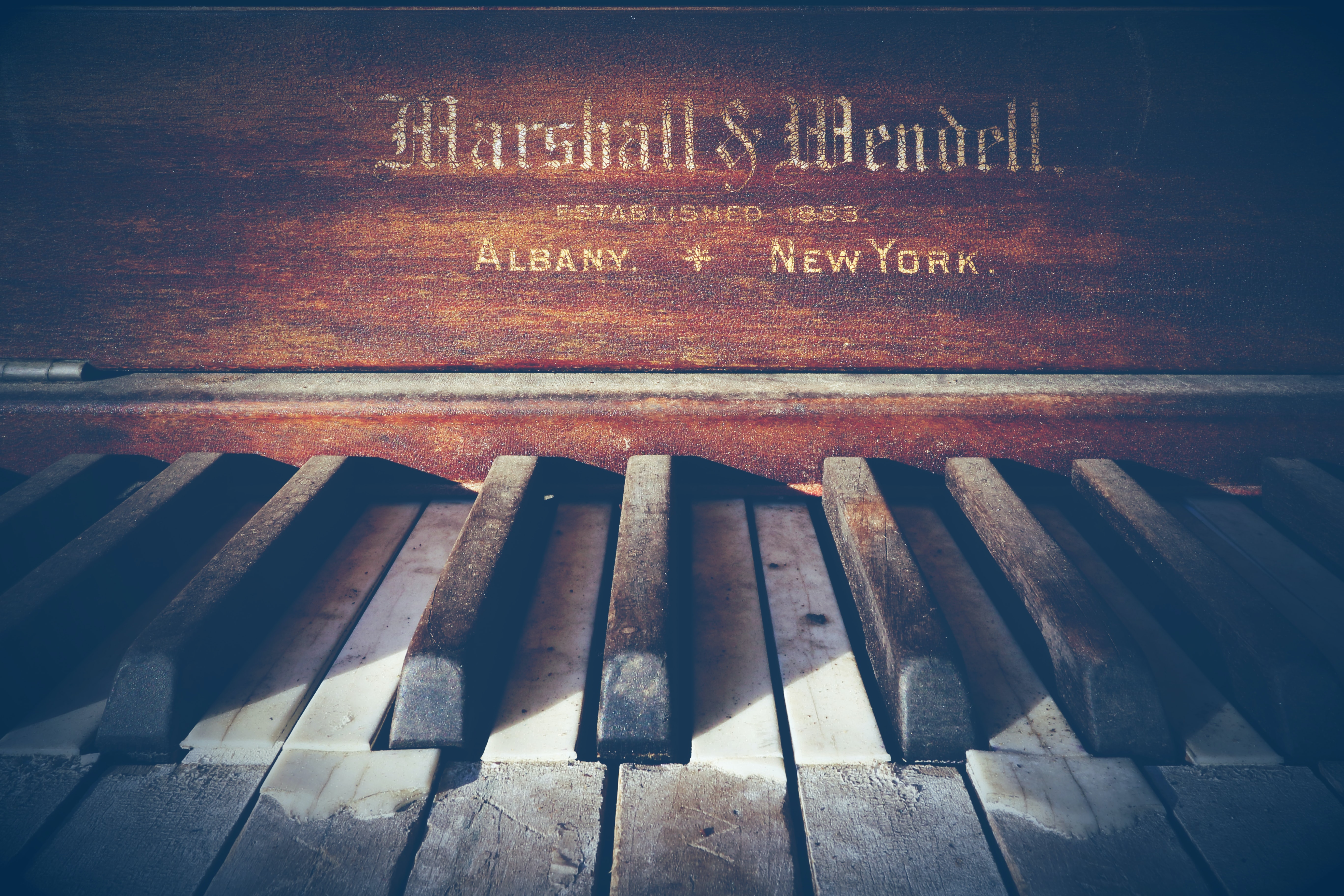 A beatdown piano with the legend Marshal & Mendel. Established 1853. Albany, New York